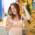 young-french-girl-with-glasses-outdoors-celebrating-victory_1368-509493